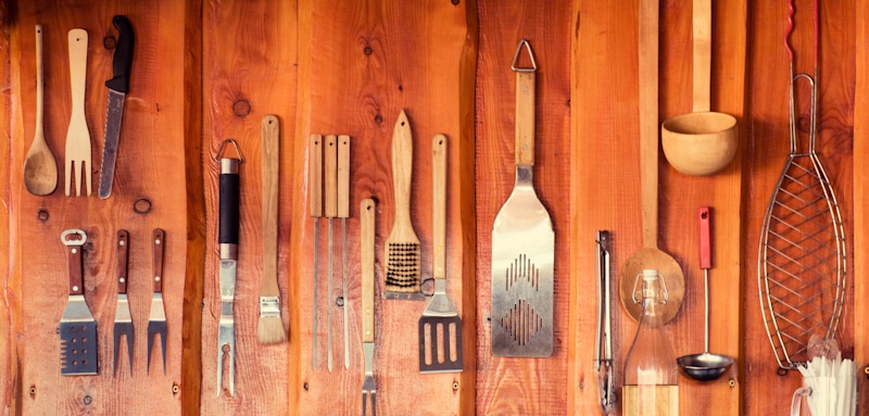 BBQ tools in wooden wall
